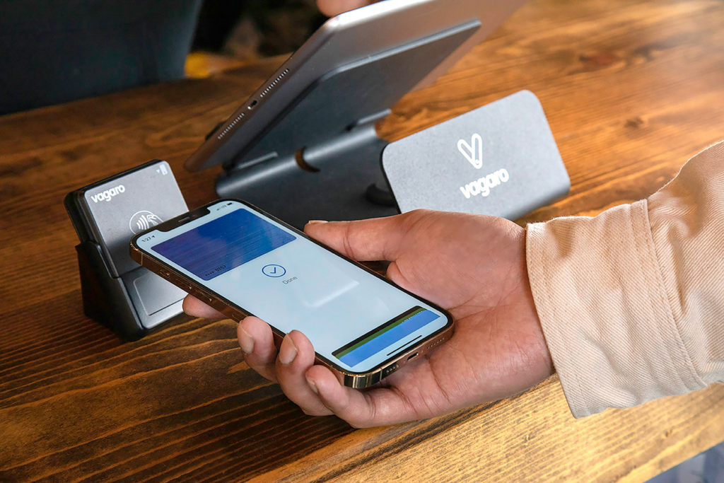 Client paying in crypto at coffee shop with his cryptocurrency using Aenon Card